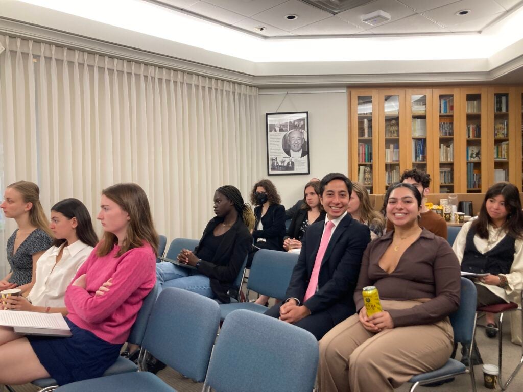 photo of students sitting in conference room during presentation