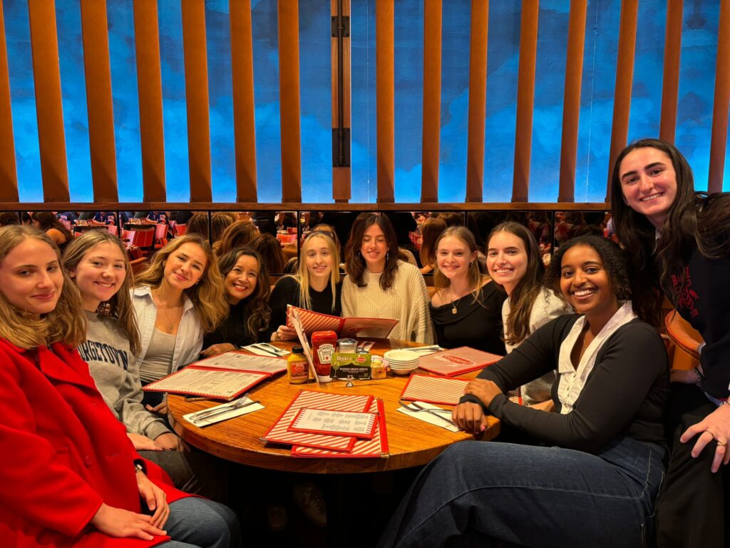 ten people sitting at a booth in a restaurant