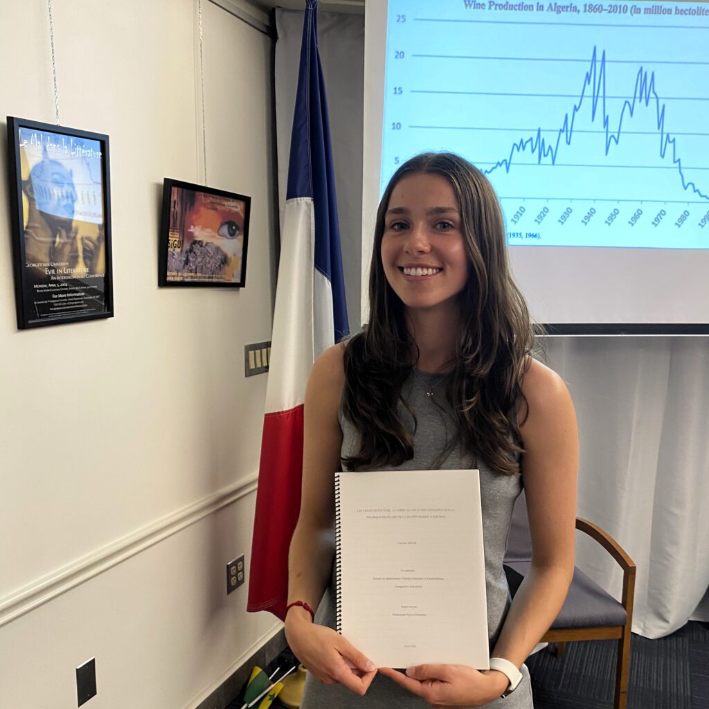 young smiling woman holding thesis book