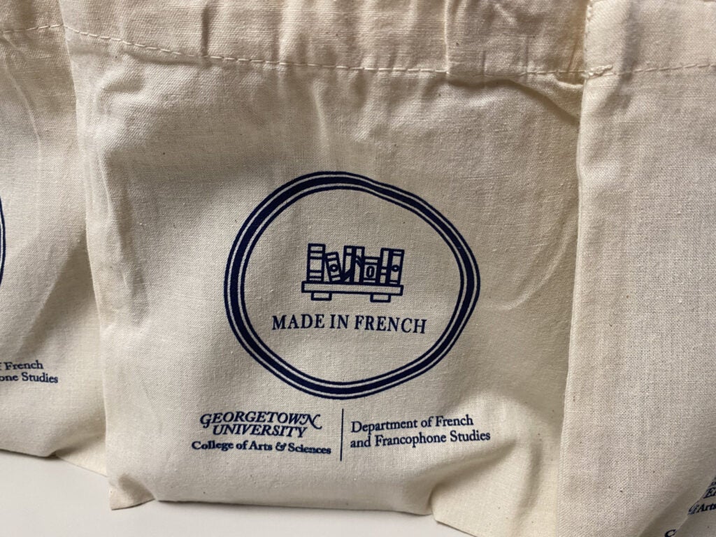 image imprinted on bag with books and text "Made in French" in circle and GU logo