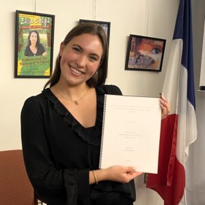 young woman holding thesis book