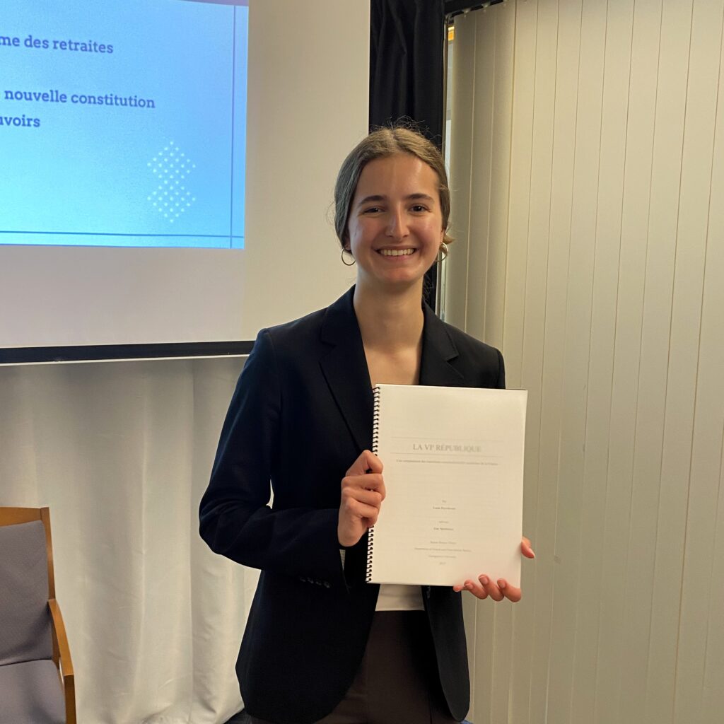 young smiling woman holding thesis book
