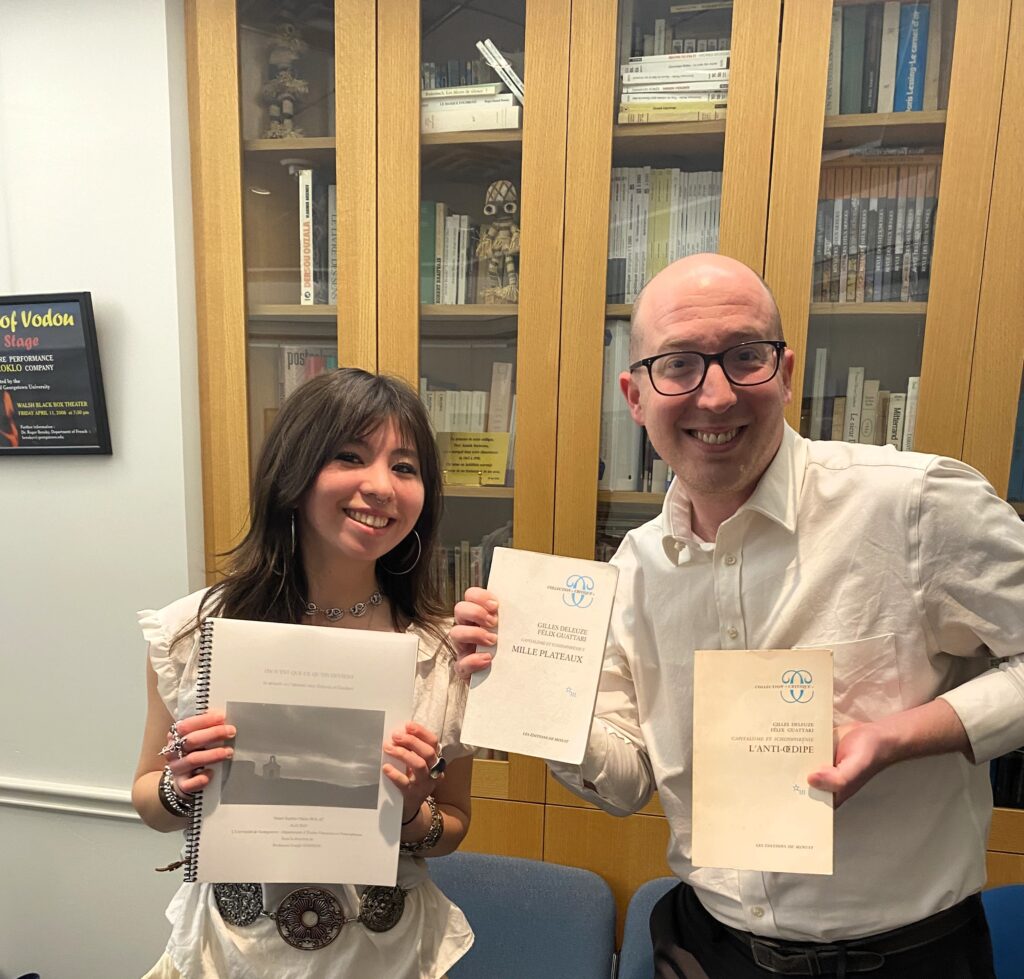Nami Bolat with advisor Joseph Johnson holding thesis and books
