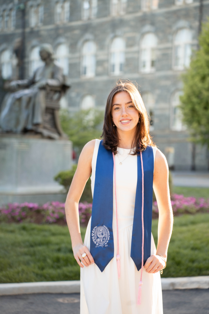 brunette White woman wearing white dress and blue graduation stole
